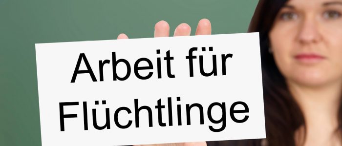 Frau mit Schild "Arbeit für Flüchtlinge"