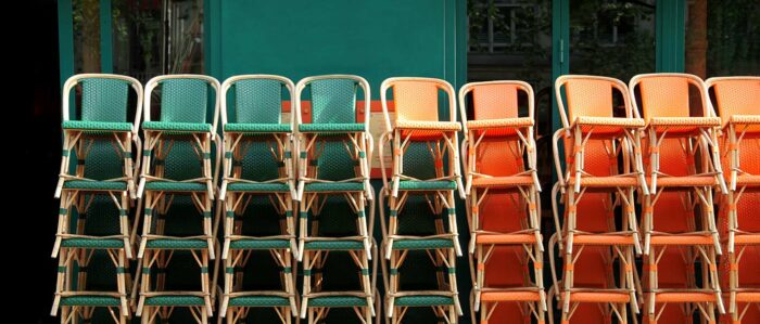 Gestapelte Stühle vor einem geschlossenen Gastronomiebetrieb.